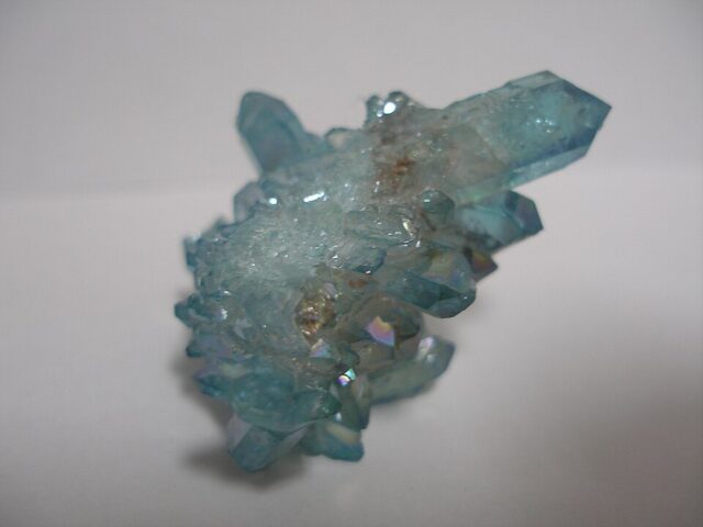 Aqua aura quartz with blue iridescent metallic coating on natural quartz crystals