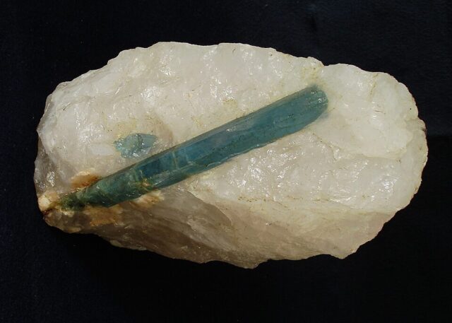 Natural pale blue aquamarine beryl crystal specimen on quartz rock