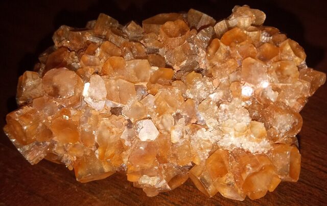 Natural aragonite mineral specimen showing crystalline structure and earthy coloration