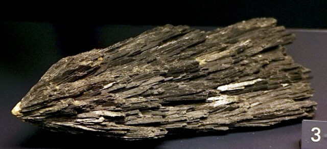 Black kyanite mineral crystal specimen showing dark fan-shaped blades