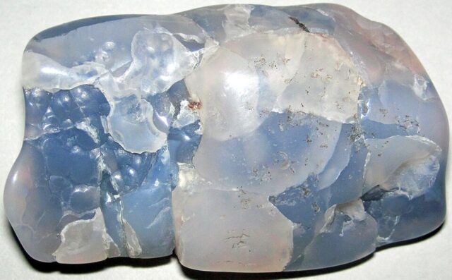 Polished blue chalcedony stone from Wyoming showing natural pale blue quartz texture