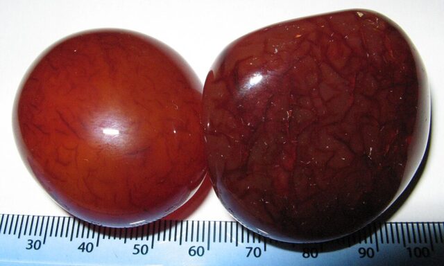 Two polished orange carnelian sard stones illustrating carnelian meaning and mineral properties