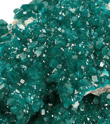 Bright emerald-green dioptase copper silicate mineral crystals on matrix