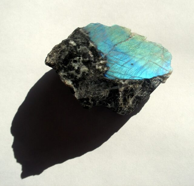 Natural labradorite gemstone specimen showing blue and green iridescent labradorescence