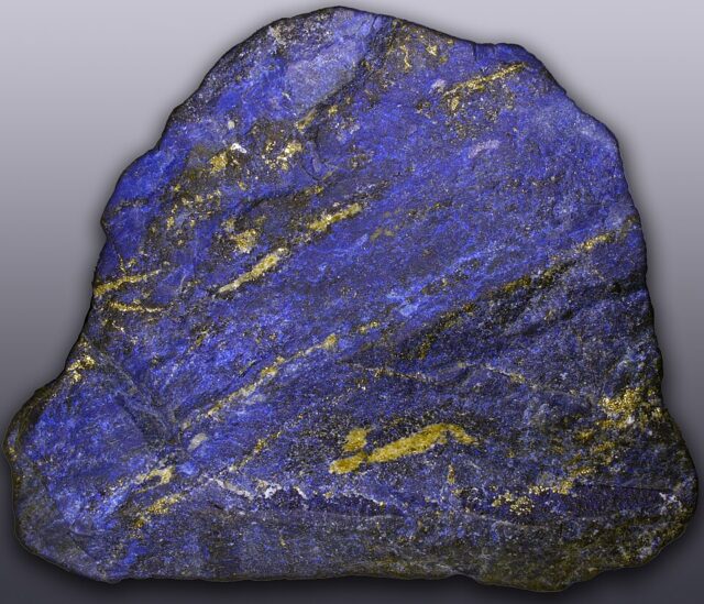 Natural rough blue lapis lazuli mineral stone with golden pyrite flecks from Afghanistan