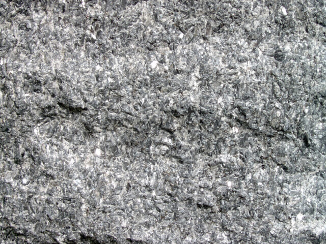 Natural larvikite rock specimen from Larvik, Norway showing blue-gray feldspar flashes