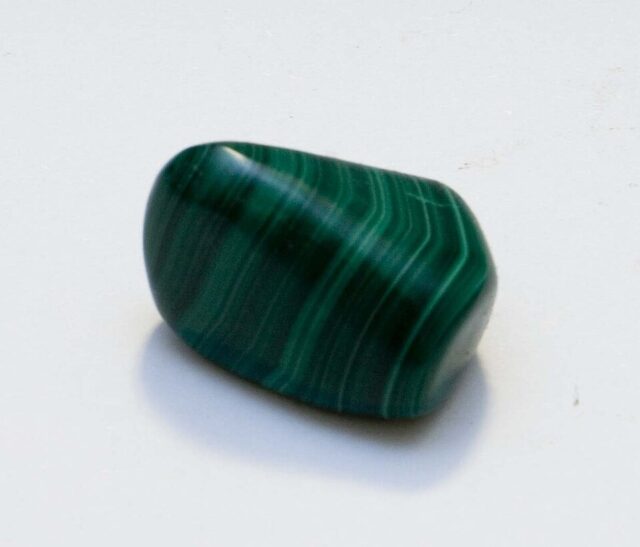 Natural green malachite mineral specimen showing banded copper carbonate texture