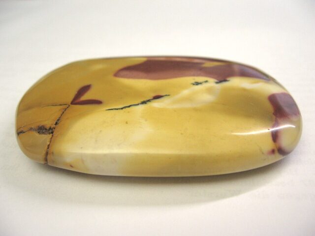 Polished Australian mookaite jasper gemstone showing characteristic yellow and red tones