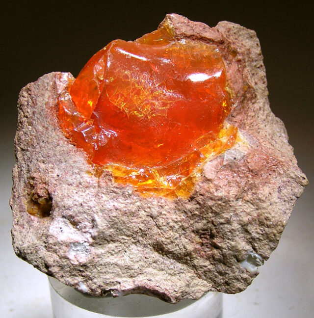 Natural fiery orange Mexican fire opal specimen in rock matrix from Chihuahua, Mexico