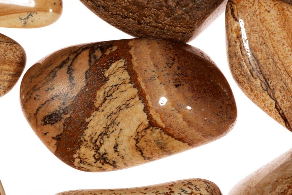 Close-up of natural picture jasper gemstone with layered brown landscape-like patterns