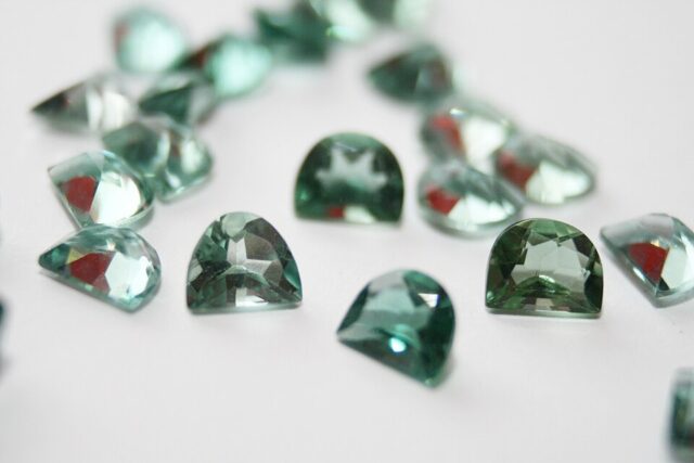 Faceted green prasiolite quartz gemstones in multiple light green shades