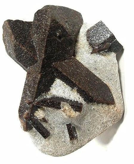 Natural staurolite mineral crystals showing cross-shaped twinning
