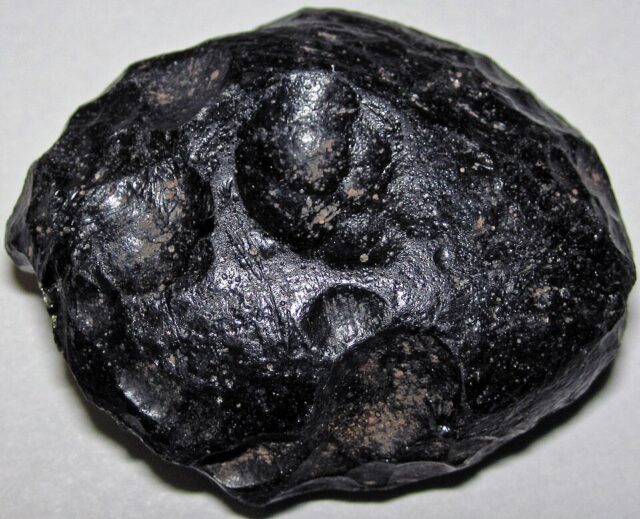 Natural black indochinite tektite impact glass specimen from southeastern Asia