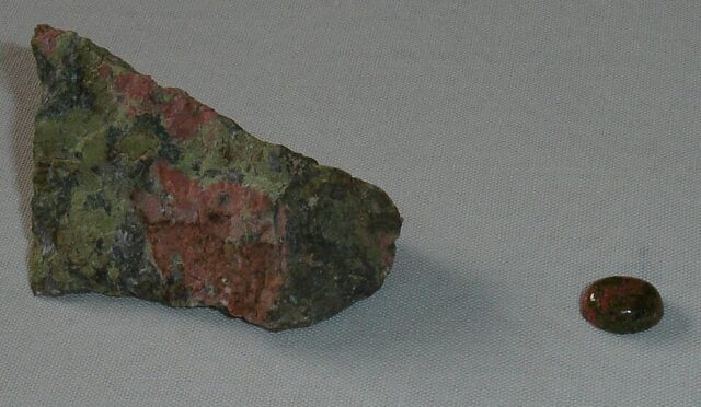 Natural unakite rough rock and polished cabochon showing pink feldspar and green epidote