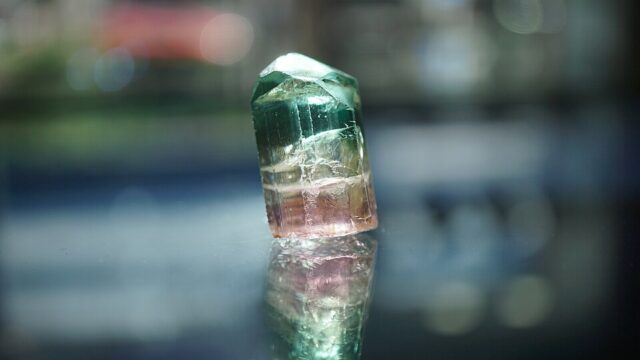 Natural rough bicolored watermelon tourmaline crystal with pink and green zones