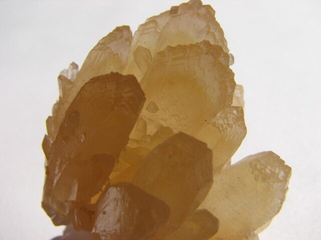 Natural golden yellow calcite mineral crystals with translucent crystalline faces