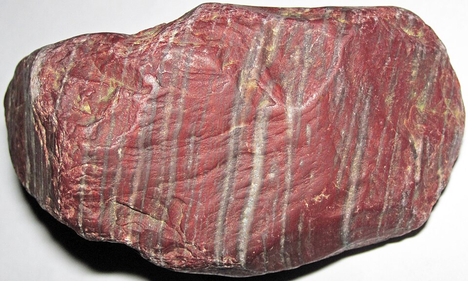 Natural zebra-pattern banded jasper hematitic chert pebble from Honduras with striped red mineral bands